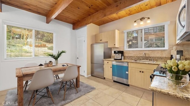 kitchen with light brown cabinets, light tile patterned flooring, sink, and appliances with stainless steel finishes