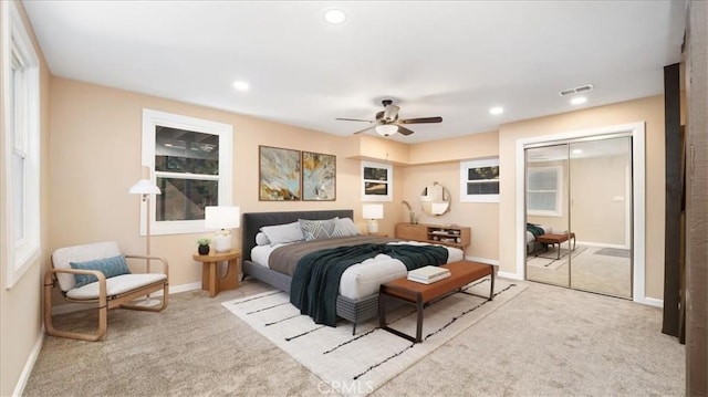 carpeted bedroom with a closet and ceiling fan