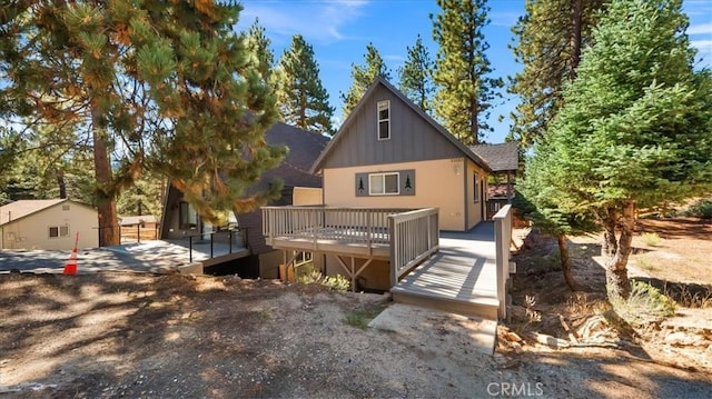 rear view of property with a wooden deck