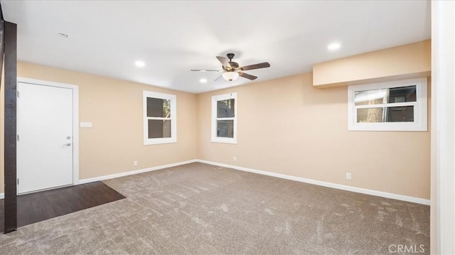 carpeted spare room with ceiling fan