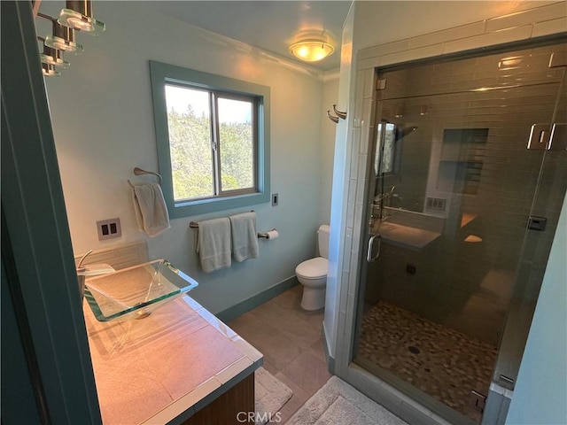 bathroom with toilet, vanity, and walk in shower