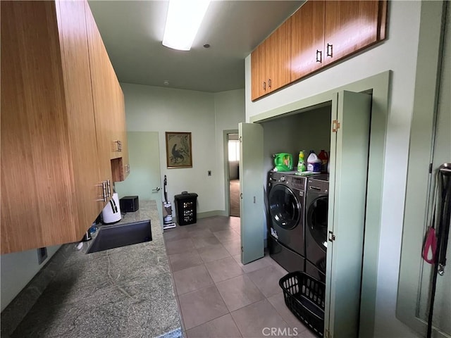 clothes washing area with light tile patterned floors and washer and clothes dryer