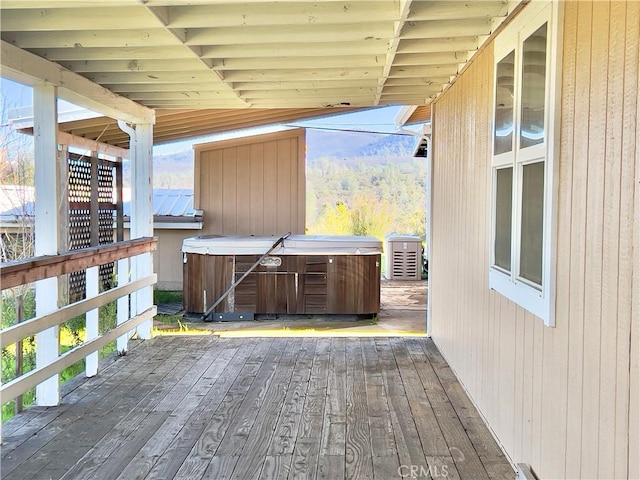 wooden deck with a hot tub