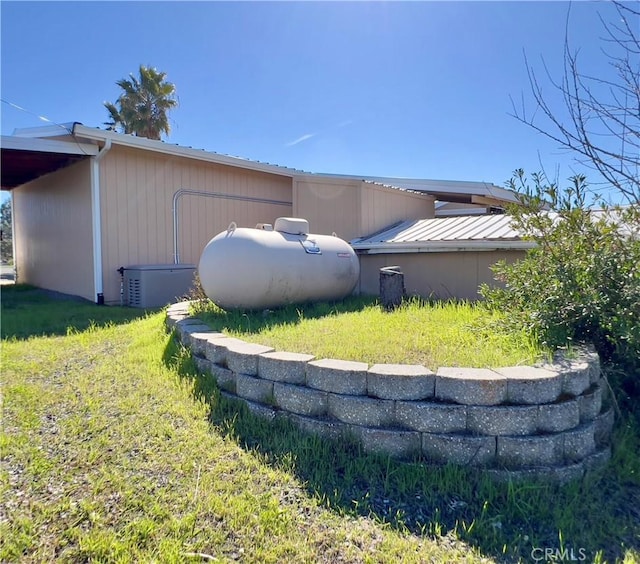 view of side of home featuring a yard