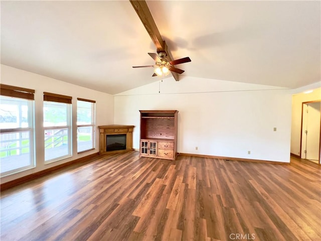 unfurnished living room with ceiling fan, dark hardwood / wood-style floors, and vaulted ceiling with beams