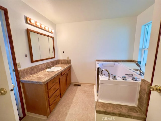 bathroom featuring vanity and a washtub