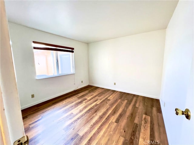 unfurnished room featuring dark wood-type flooring