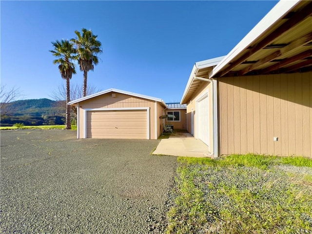 exterior space with a garage and a mountain view