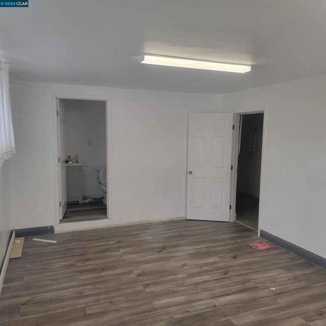 unfurnished room featuring dark hardwood / wood-style floors