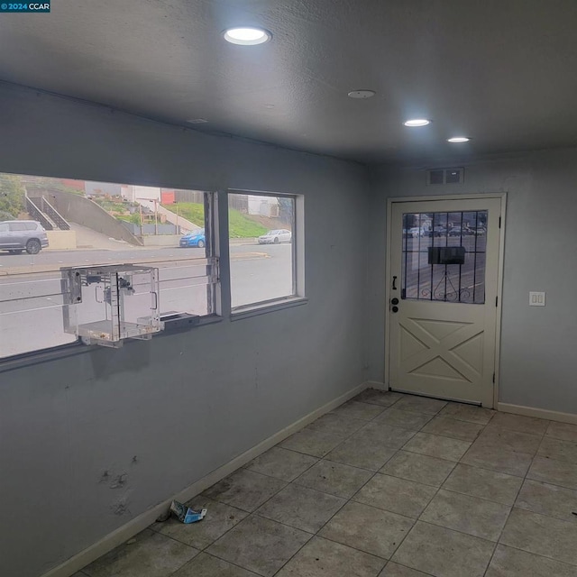 foyer entrance featuring light tile patterned floors