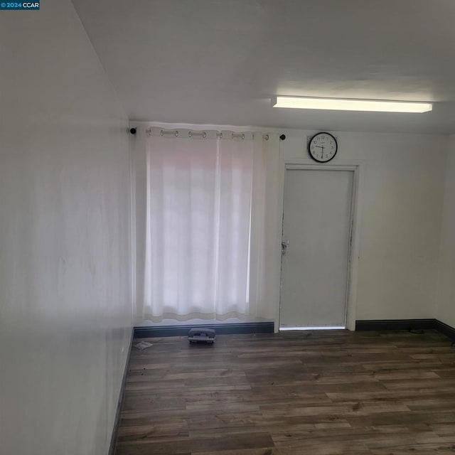 spare room with dark wood-type flooring