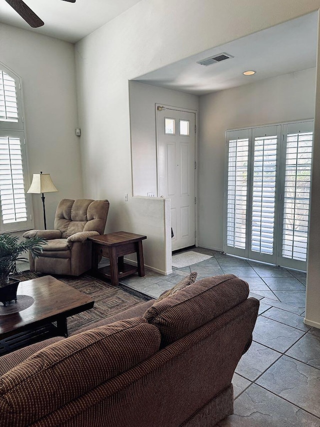 living room featuring plenty of natural light and ceiling fan