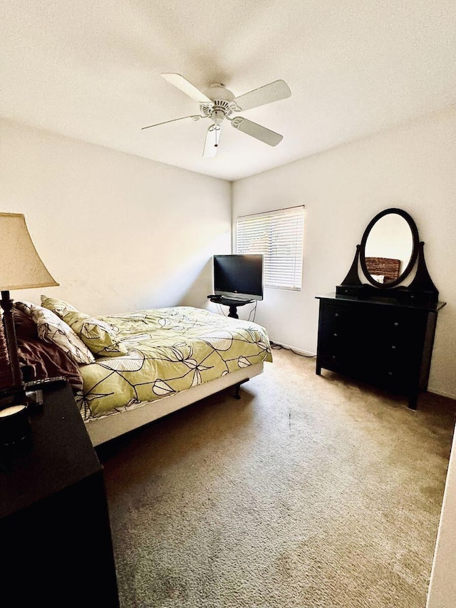 bedroom with ceiling fan and carpet