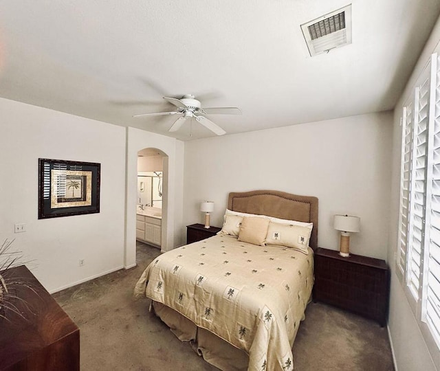 carpeted bedroom featuring ceiling fan and connected bathroom