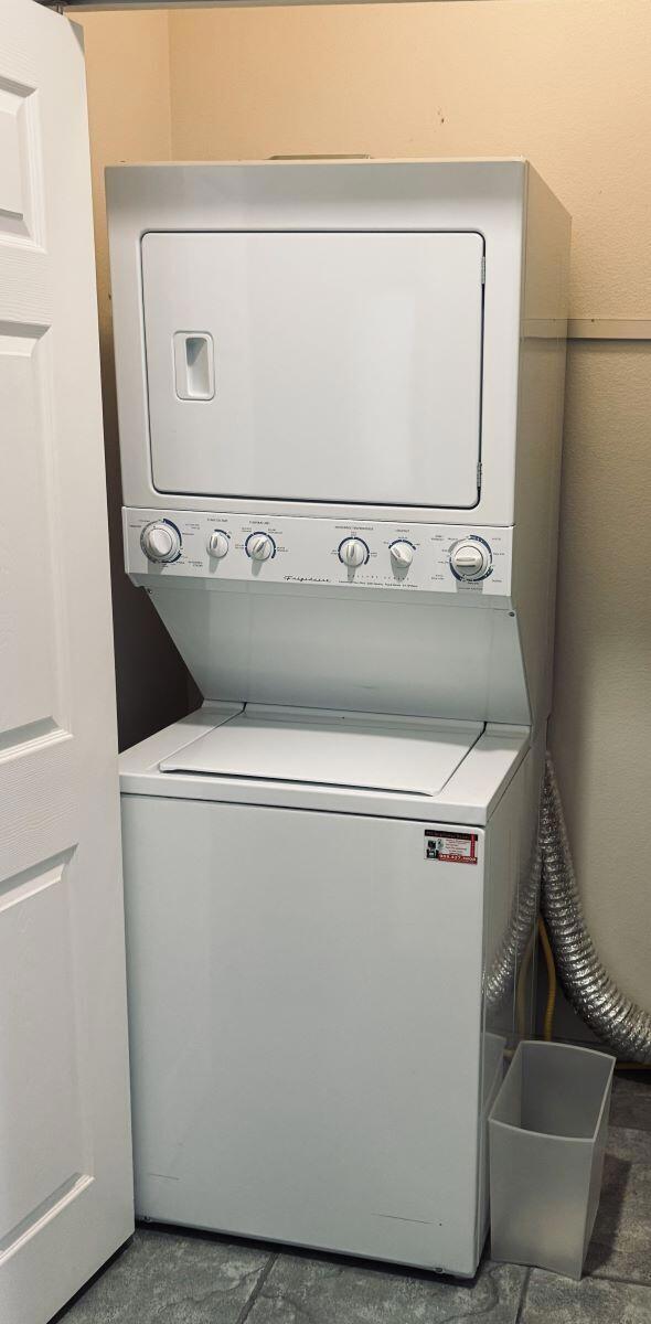 laundry area featuring stacked washer and dryer