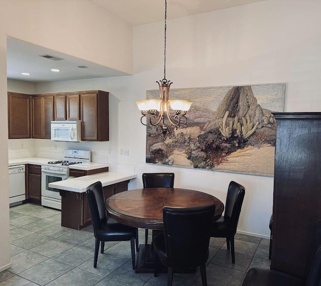 tiled dining area featuring a chandelier