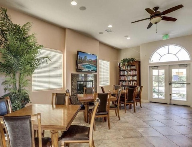 tiled dining space with french doors and ceiling fan