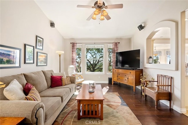 living room featuring ceiling fan, dark hardwood / wood-style flooring, and vaulted ceiling