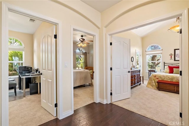 corridor featuring lofted ceiling and hardwood / wood-style flooring