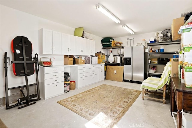 kitchen featuring white cabinets and stainless steel refrigerator with ice dispenser