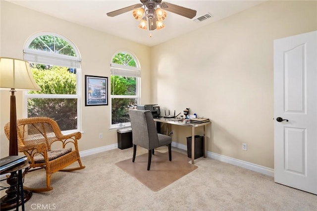 carpeted home office with ceiling fan