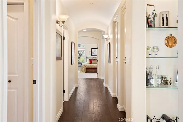 corridor featuring dark hardwood / wood-style flooring