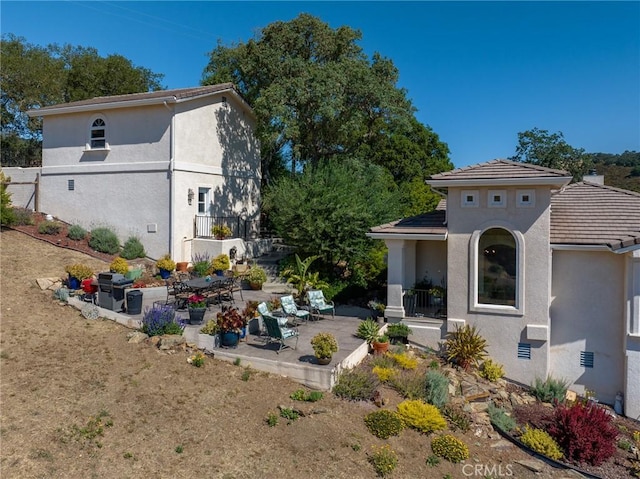 back of house featuring a patio area