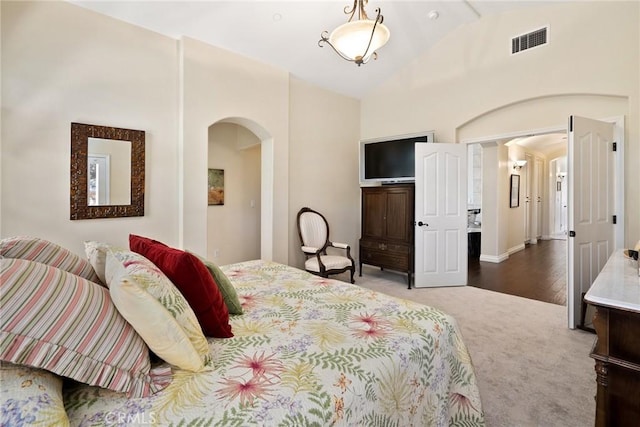 bedroom with hardwood / wood-style flooring and lofted ceiling