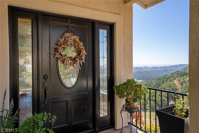 14600 El Monte Rd, Atascadero, CA 93422 - property entrance featuring stucco siding, a mountain view, and a balcony