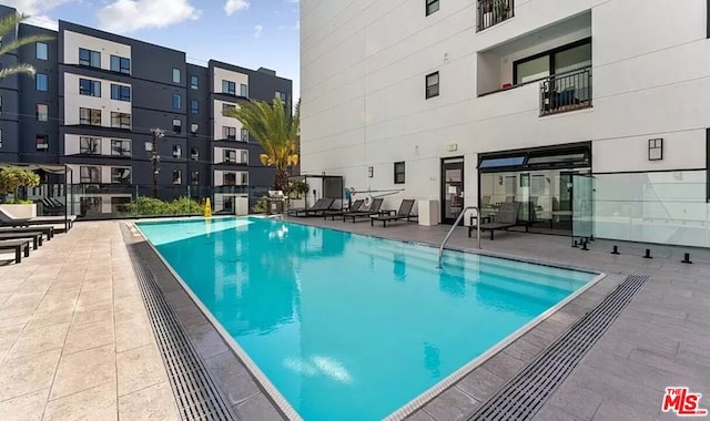 view of swimming pool with a patio