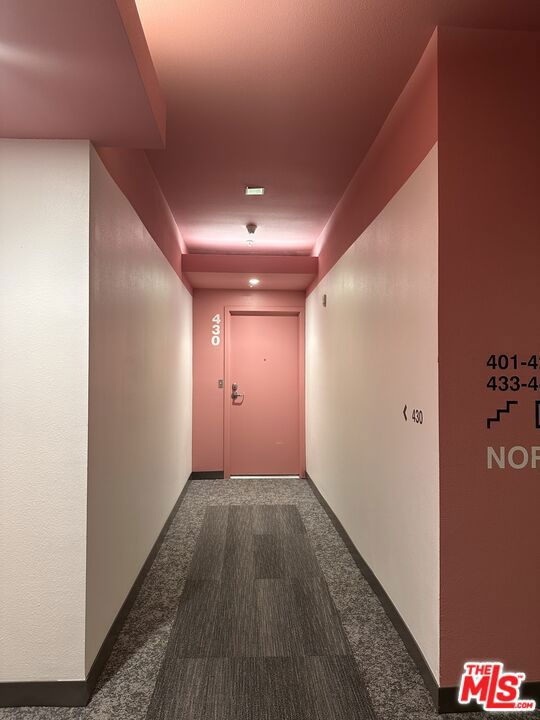 corridor with dark carpet