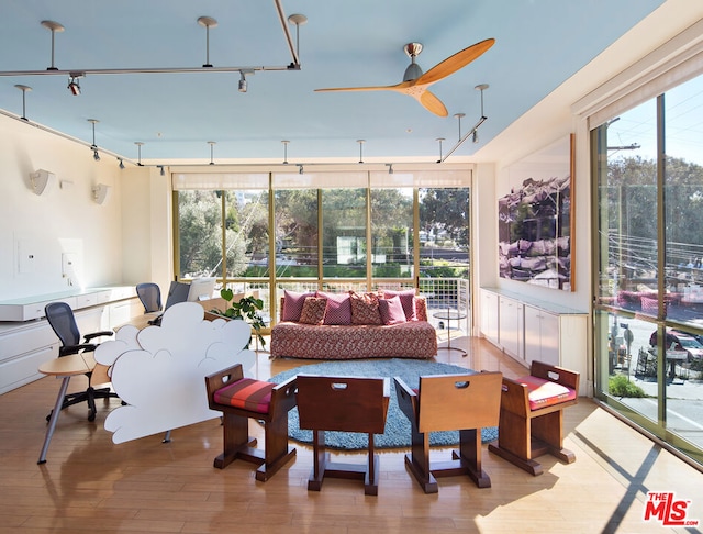 sunroom / solarium featuring ceiling fan