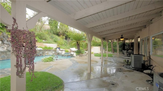 view of patio / terrace with ceiling fan, cooling unit, and a fenced in pool