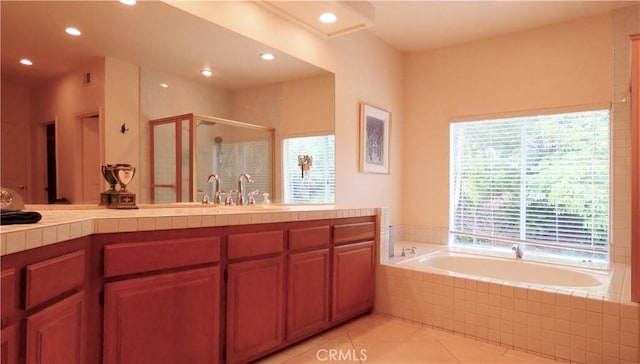 bathroom with vanity, tile patterned floors, and shower with separate bathtub