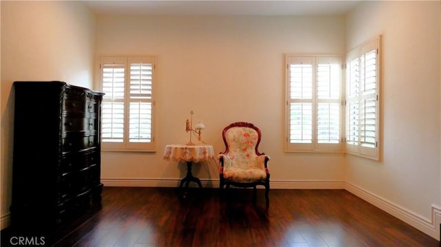 sitting room with dark hardwood / wood-style flooring