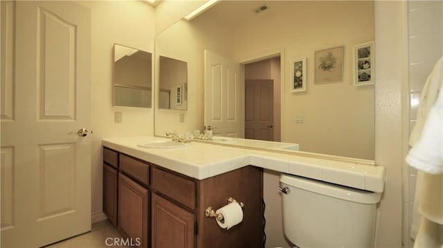 bathroom with tile patterned floors, vanity, and toilet