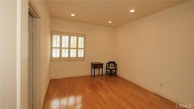 empty room with light hardwood / wood-style flooring