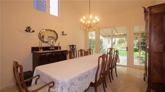 dining space featuring light tile patterned floors and a notable chandelier