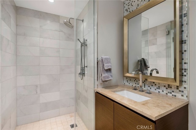 bathroom with tasteful backsplash, vanity, and an enclosed shower