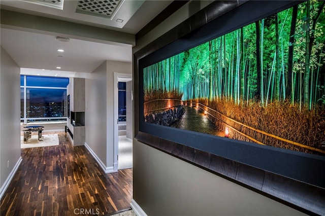 corridor with dark hardwood / wood-style flooring