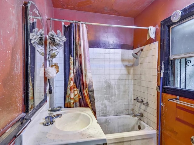 bathroom with sink and shower / bathtub combination with curtain