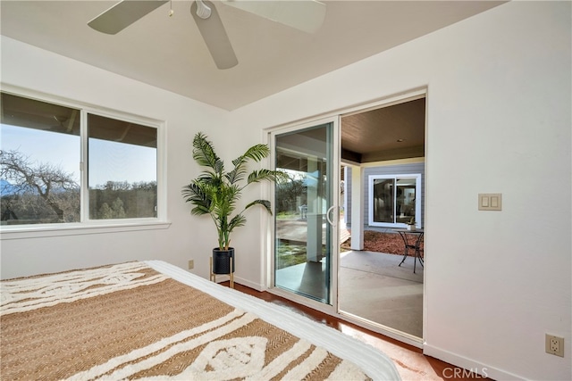 bedroom with ceiling fan, hardwood / wood-style flooring, access to outside, and multiple windows