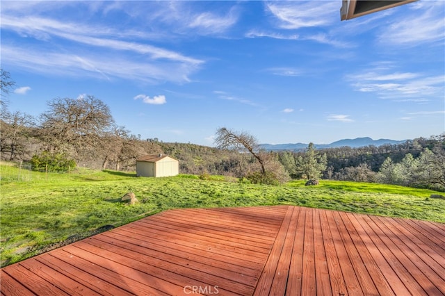 deck with a storage unit and a mountain view