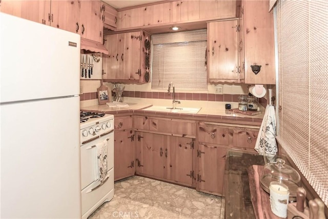 kitchen with tile countertops, sink, and white appliances