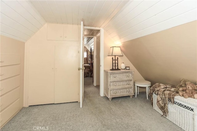 additional living space featuring light colored carpet, lofted ceiling, and wood ceiling