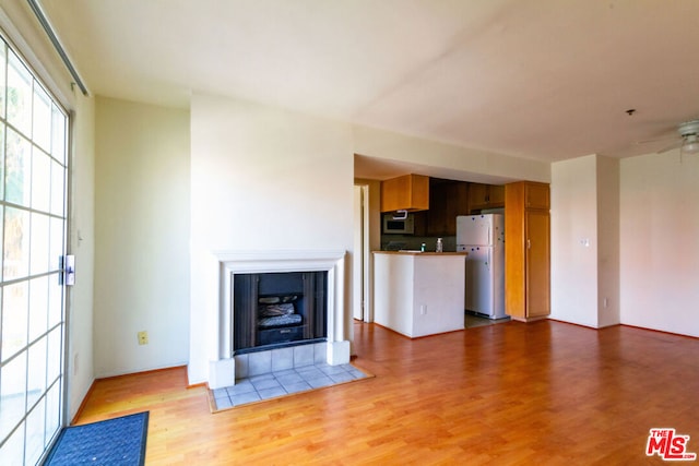 unfurnished living room featuring light hardwood / wood-style flooring and ceiling fan