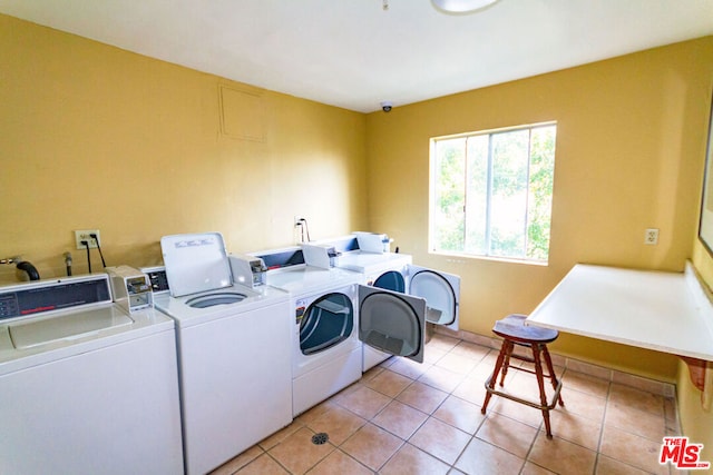 washroom featuring separate washer and dryer and light tile patterned floors