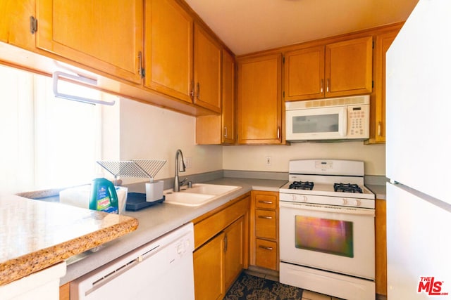 kitchen featuring white appliances and sink