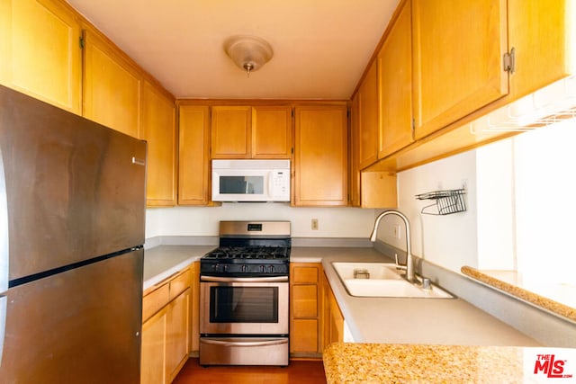 kitchen with sink, stainless steel appliances, and dark hardwood / wood-style floors