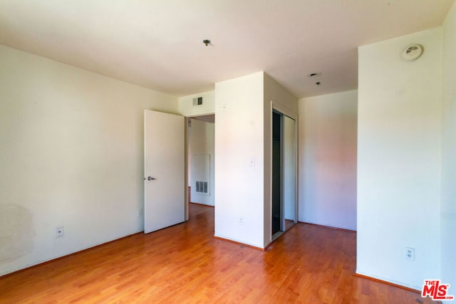 empty room featuring wood-type flooring